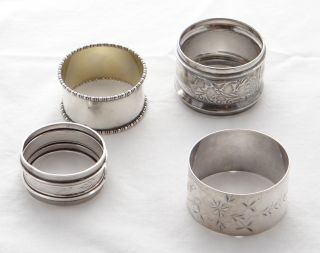 These are four unmatched silver napkin rings. Here are the details